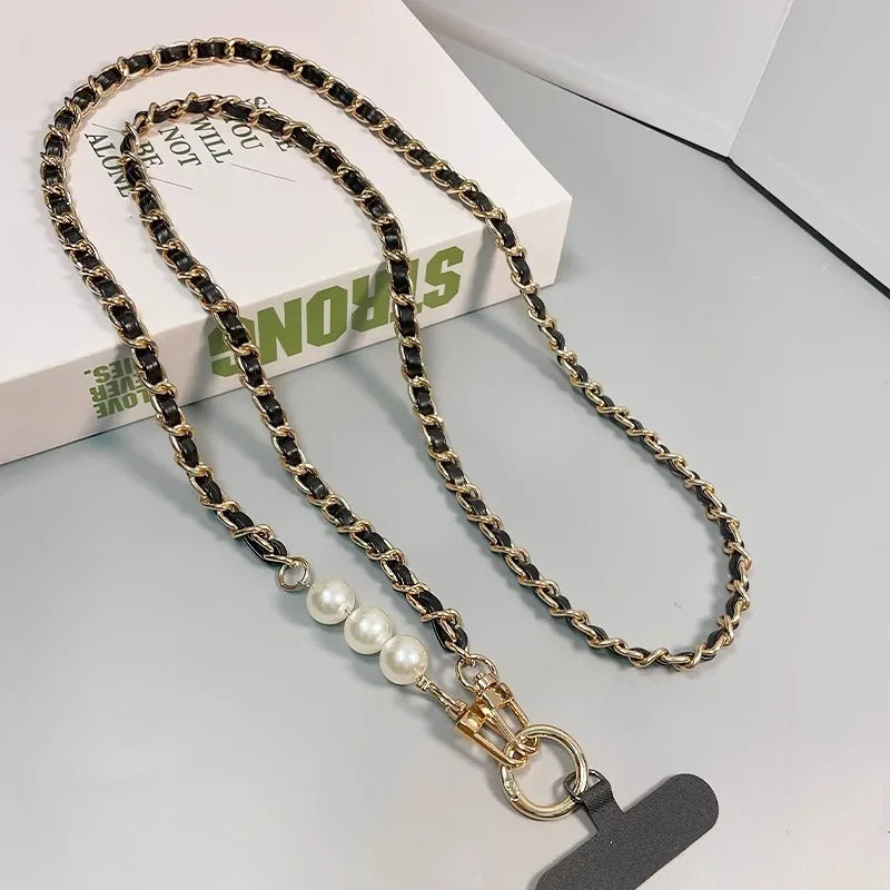 Chain lanyard with pearl charm on a gray surface