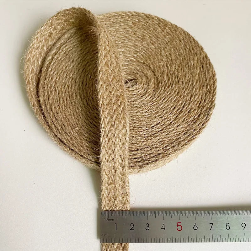 Roll of jute twine with a ruler for scale on a white background