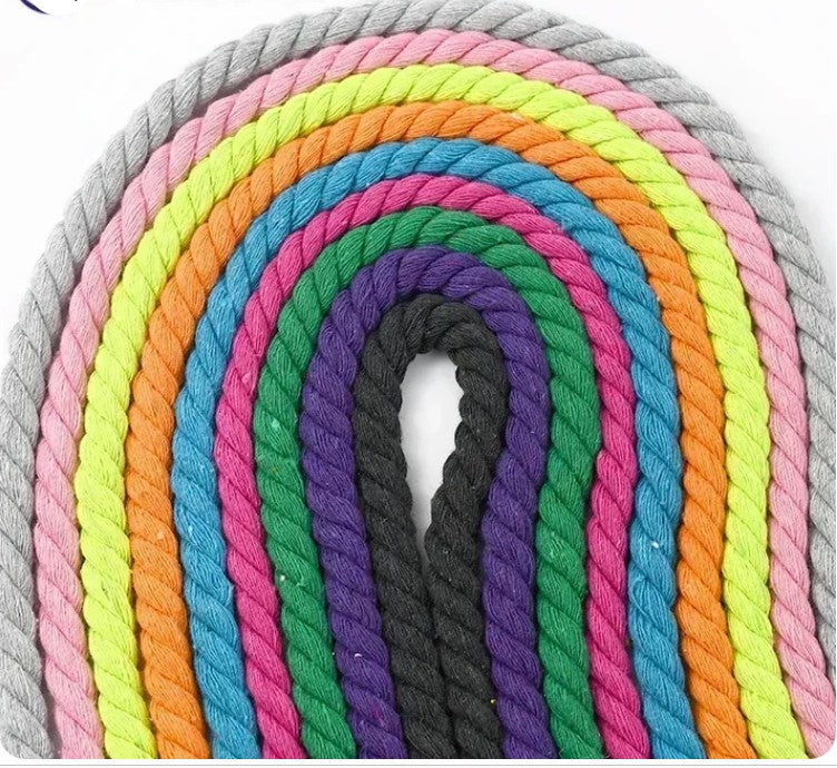 A set of thick twisted cotton macrame ropes arranged in concentric arches, showing multiple colors including gray, pink, yellow, blue, green, purple, orange, and black on a white background.