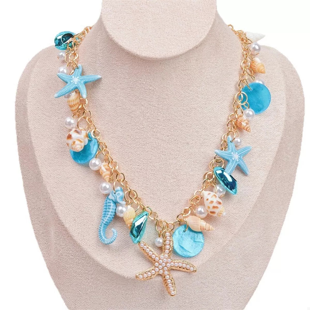 Necklace with starfish, seahorse, and shell charms on a mannequin bust.