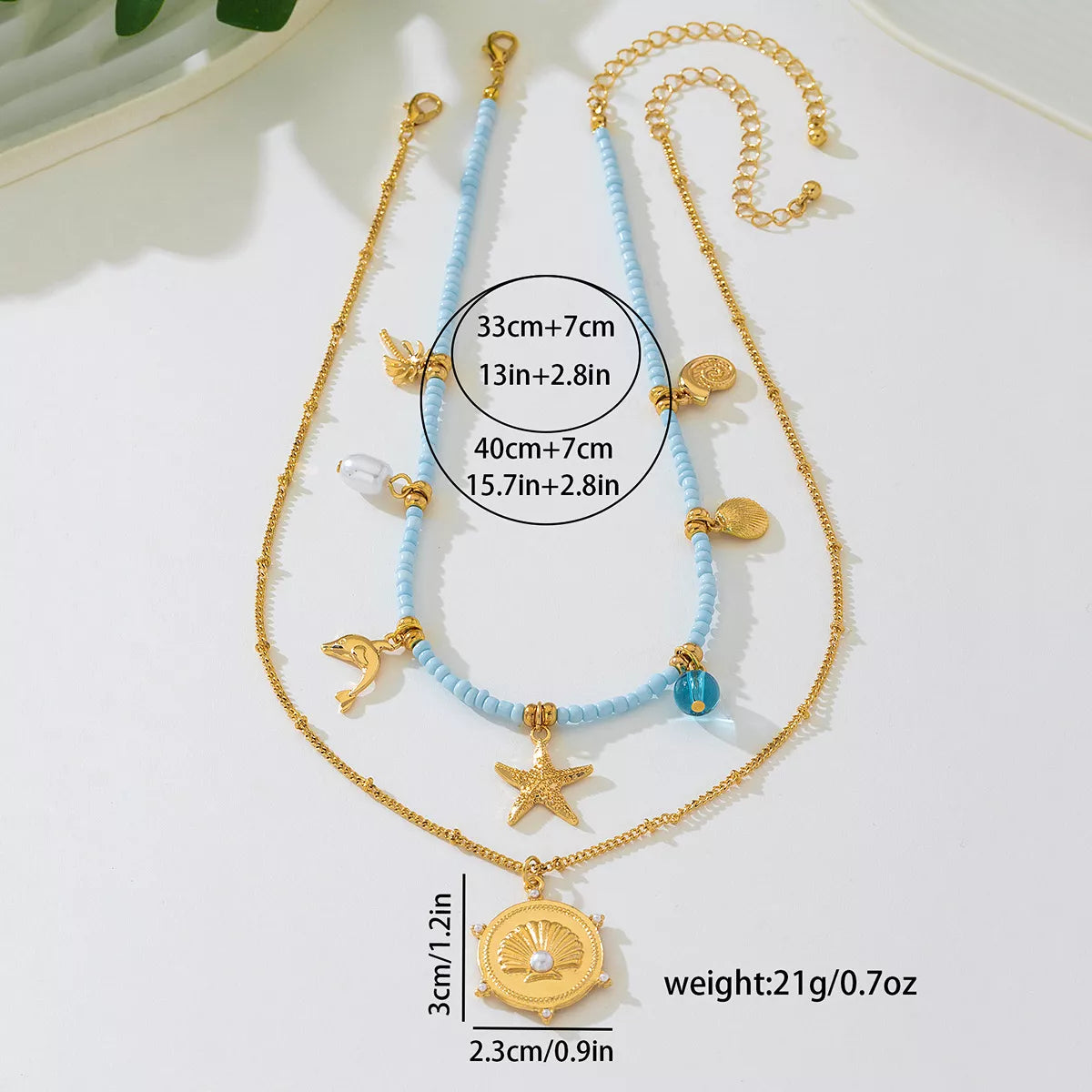 Two necklaces with decorative elements on a white background