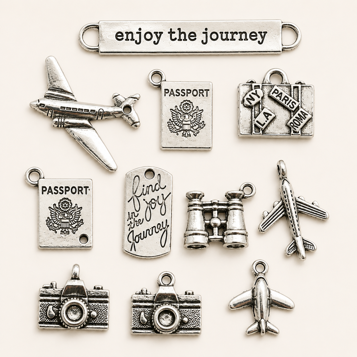 Travel charms for jewelry making featuring airplane, passport, suitcase and camera charms.