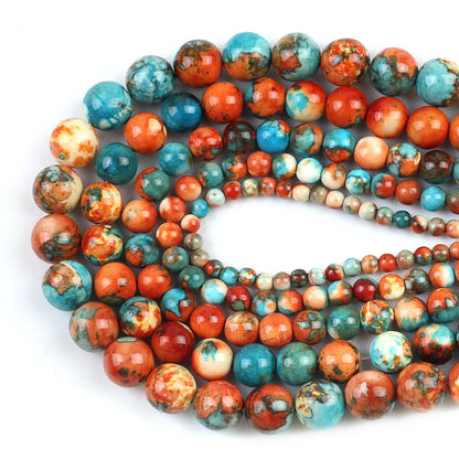 Multiple strands of polished round gemstone beads in a marbled pattern of turquoise blue, orange, red, and cream, arranged on a plain white background.