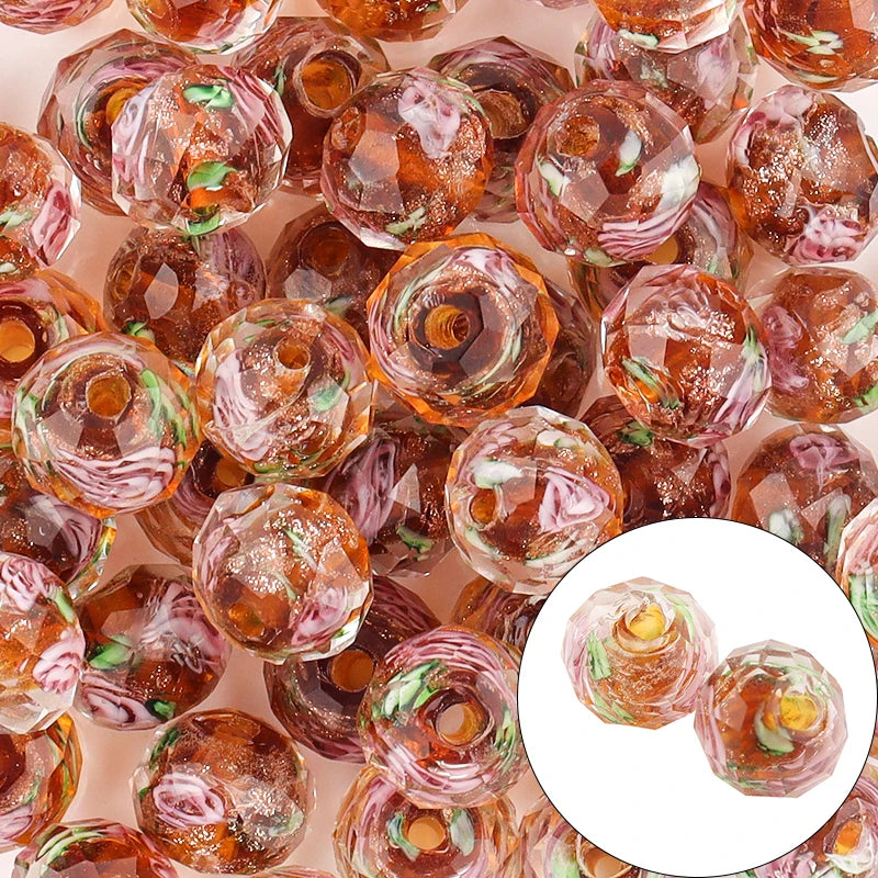 Close-up of transparent orange beads with green flecks on a pink background