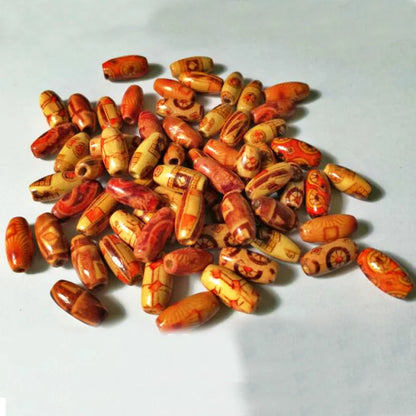 Collection of orange and brown beads on a light gray background