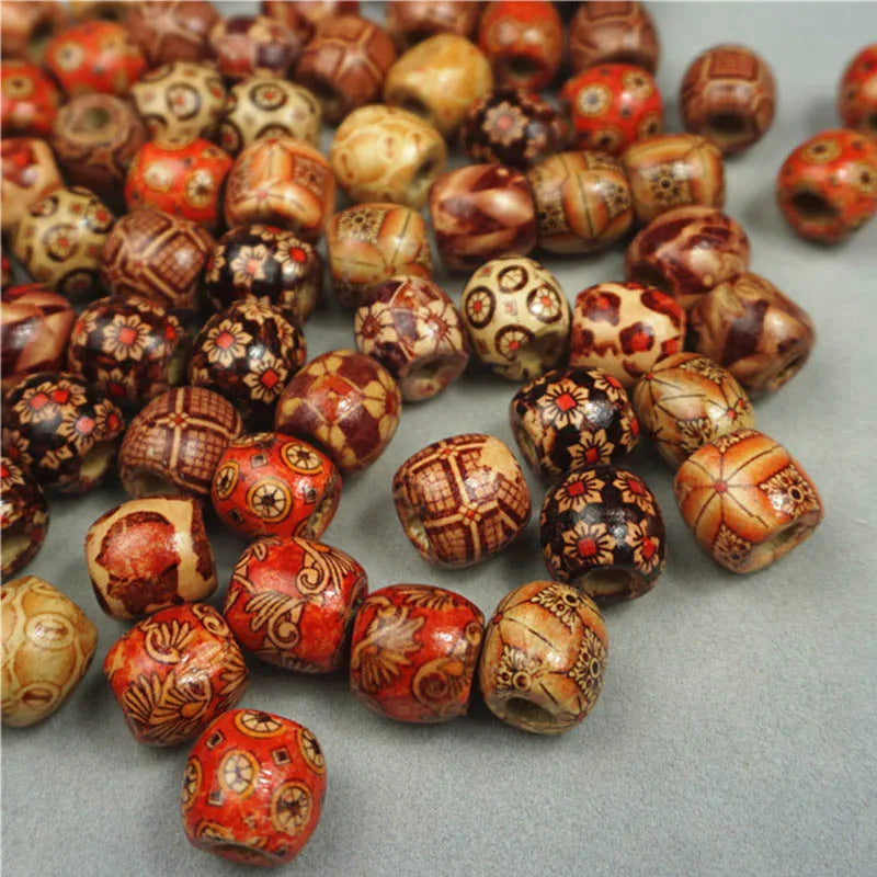 Assorted decorative beads with intricate patterns on a gray surface