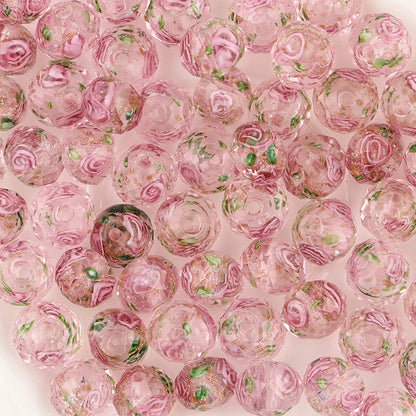 Pink glass beads with rose patterns on a pink background