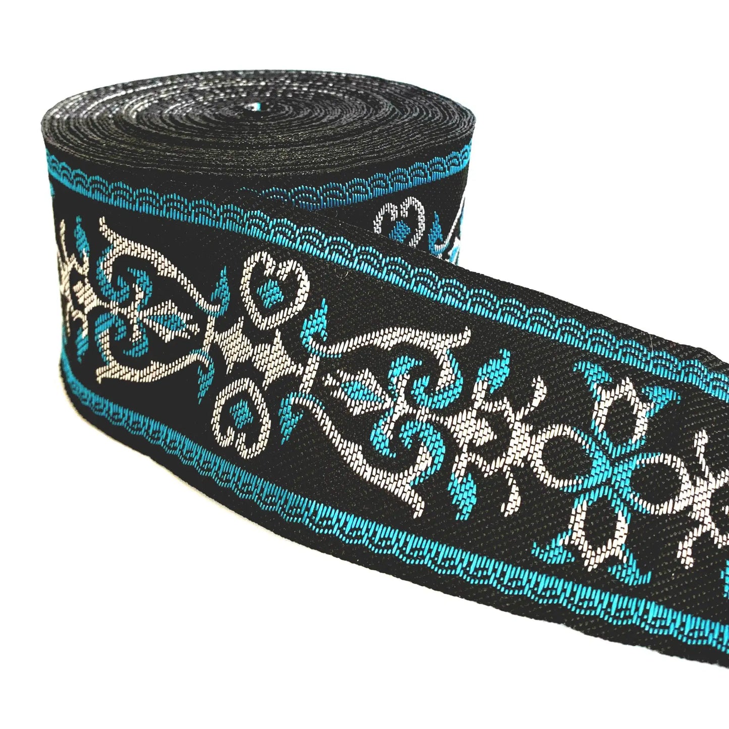 A roll of black decorative trim featuring a repeating pattern of turquoise blue and white scrollwork, shown on a plain white background.
