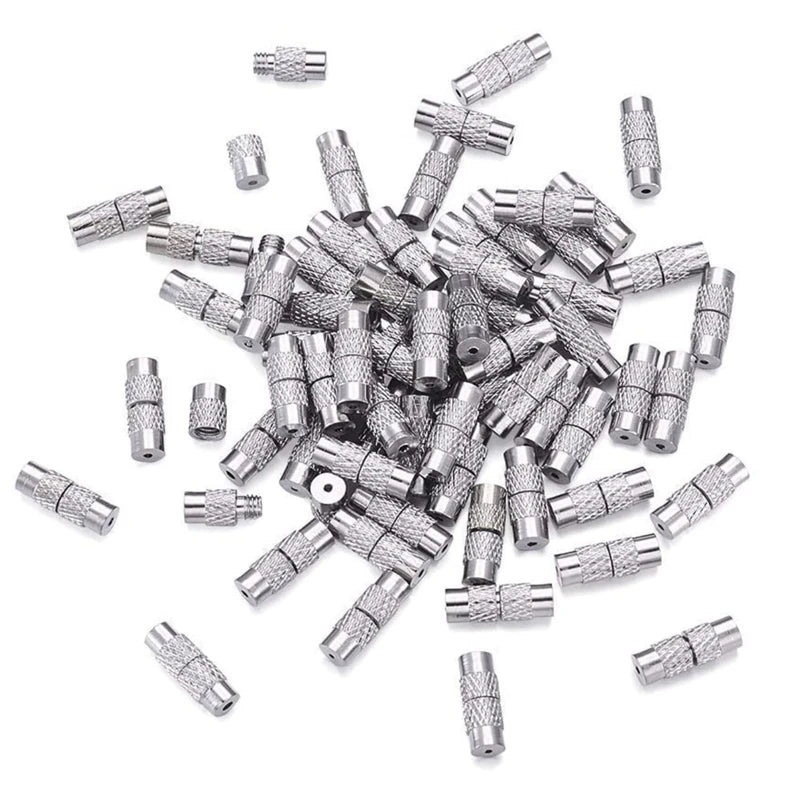 Pile of silver metal jewelry clasps on a white background