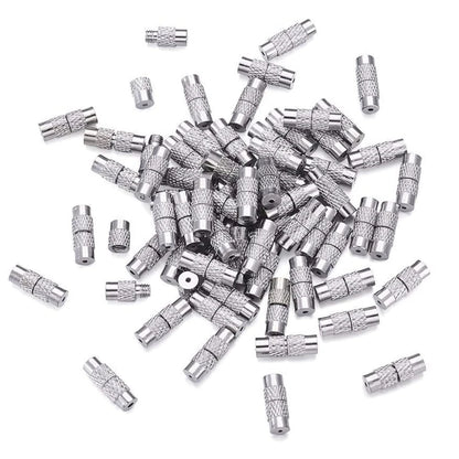 Pile of silver metal jewelry clasps on a white background