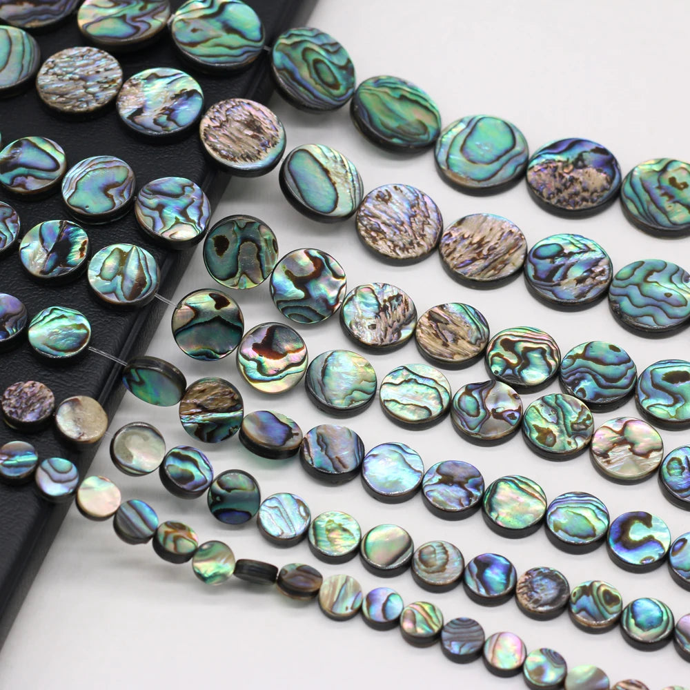 Abalone shell beads on a white background