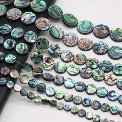 Abalone shell beads on a white background