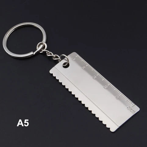 Metal ruler keychain on a black background
