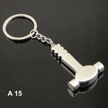 Metal keychain shaped like a bottle opener on a black background