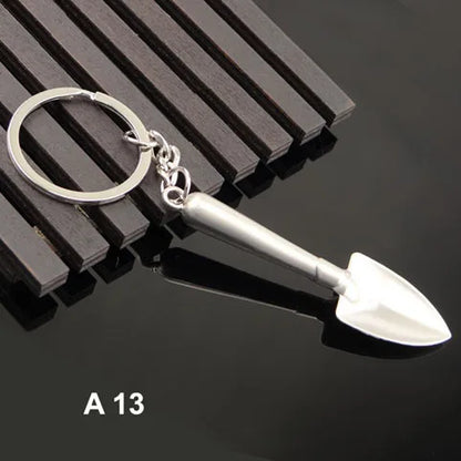 Metal keychain with a shovel design on a black background