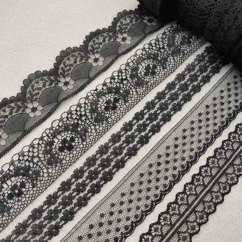 Collection of black lace trims on a light background