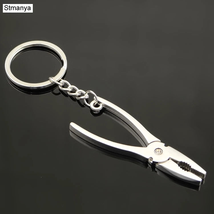 Metal plier keychain with a keyring on a black background