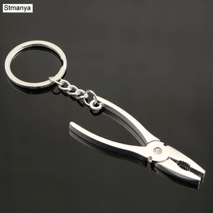 Metal plier keychain with a keyring on a black background