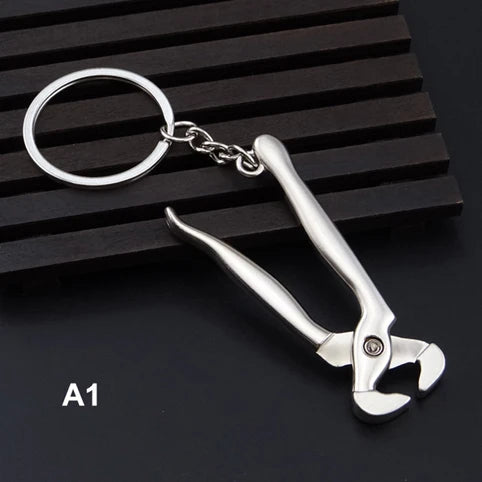 Metal wrench keychain on a black background