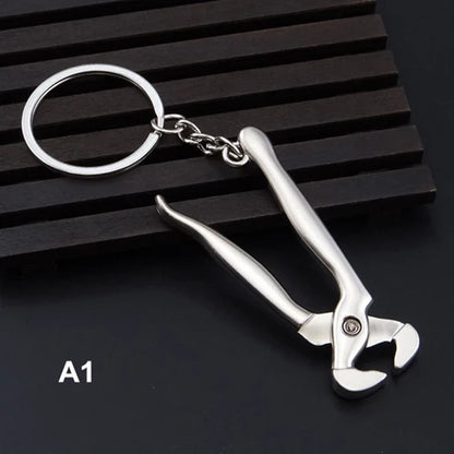 Metal wrench keychain on a black background