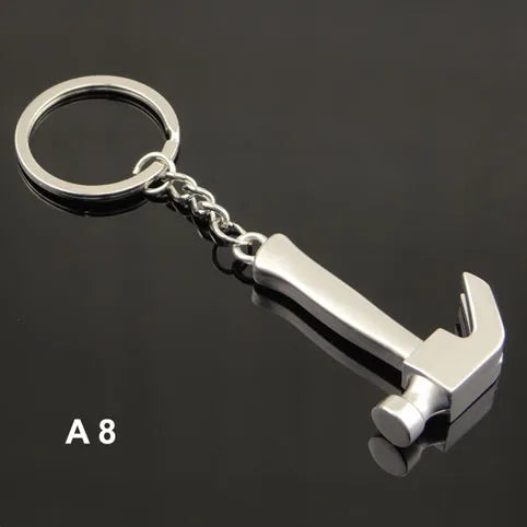 Metal hammer keychain on a black background