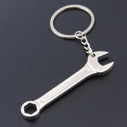 Metal wrench keychain on a dark background