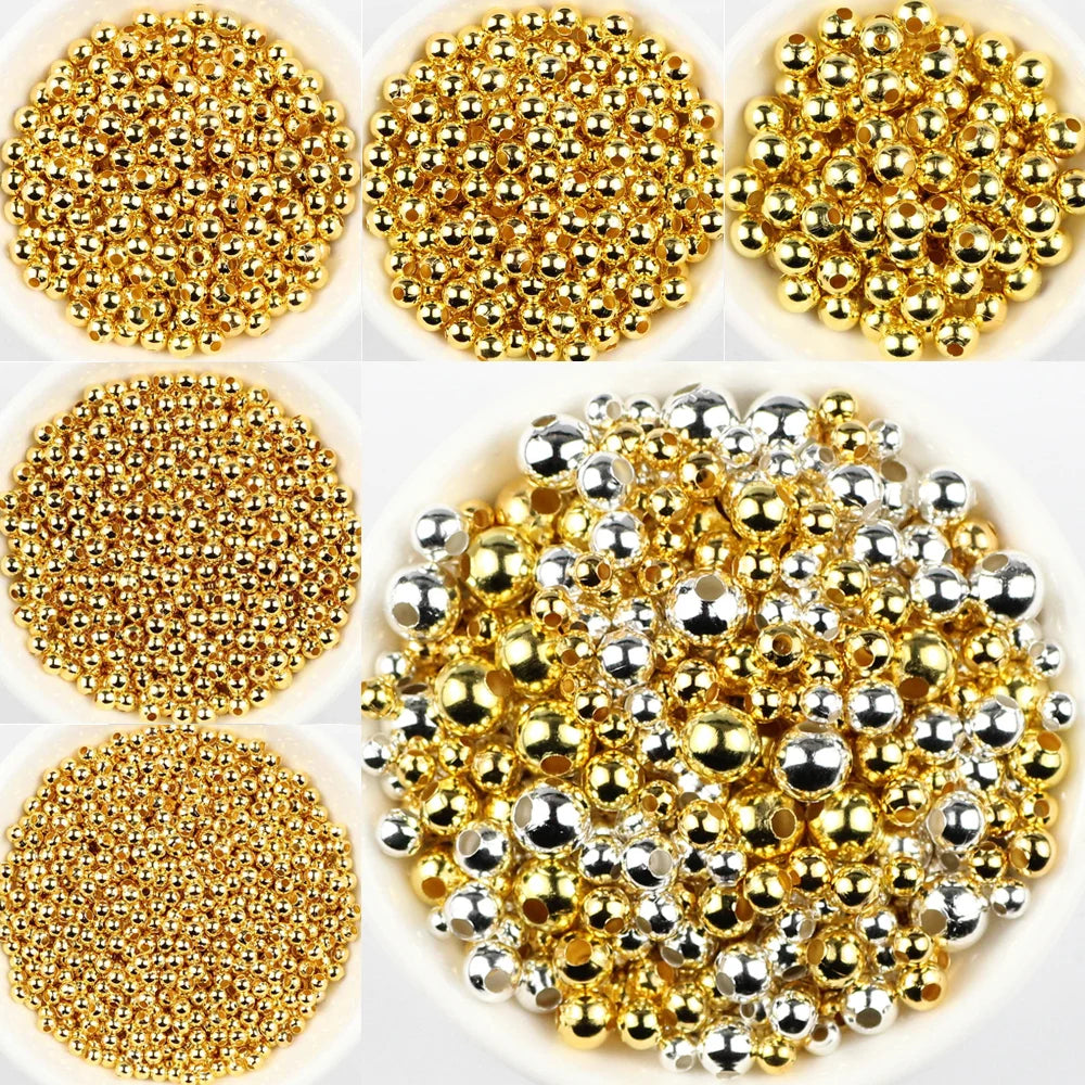 Collection of gold and silver beads on a white background