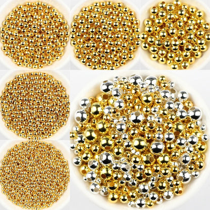 Collection of gold and silver beads on a white background