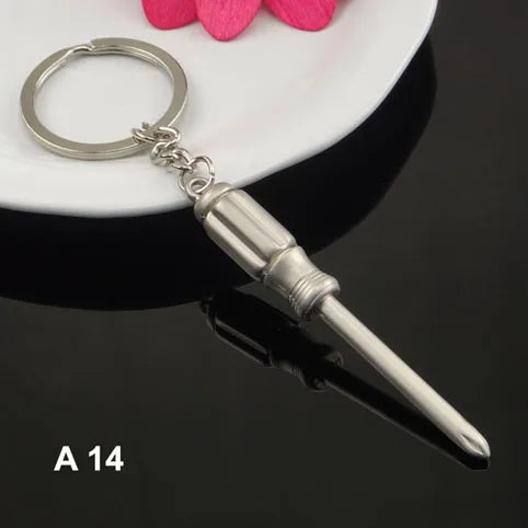 Silver keychain with a mini screwdriver on a dark surface