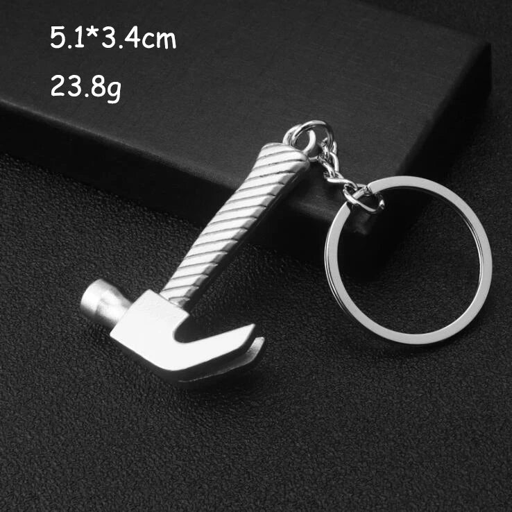 Metal keychain with a hammer design on a dark background