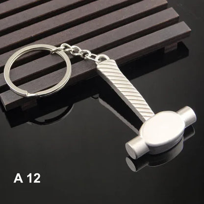 Metal hammer keychain on a dark surface