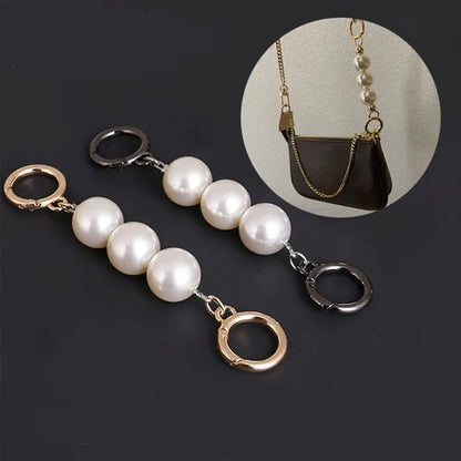 Two pearl keychain bags with silver and rose gold metal rings, displayed on a dark gray background with a circular inset showing them attached to a brown handbag.