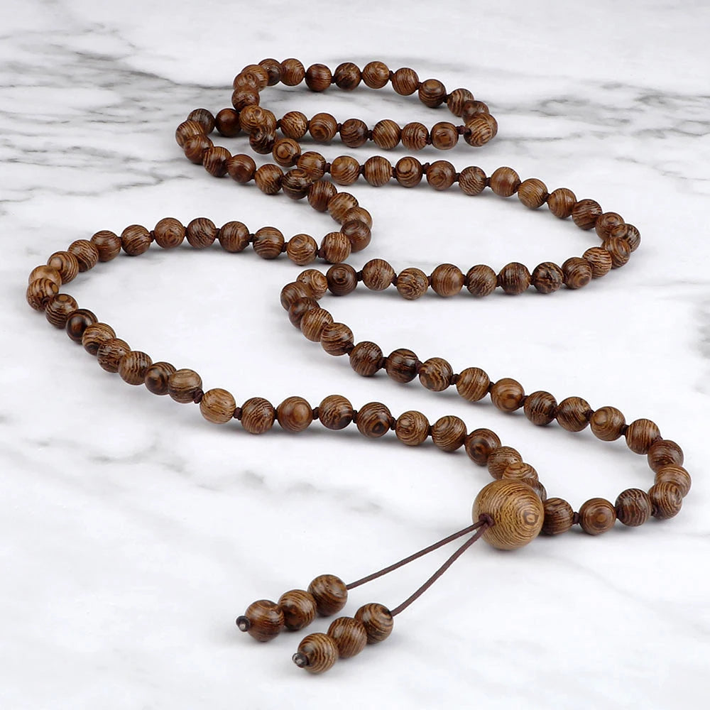 Wooden prayer beads on a marble surface