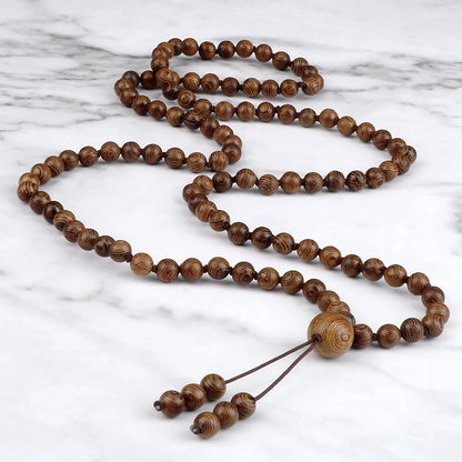 Wooden prayer beads on a marble surface