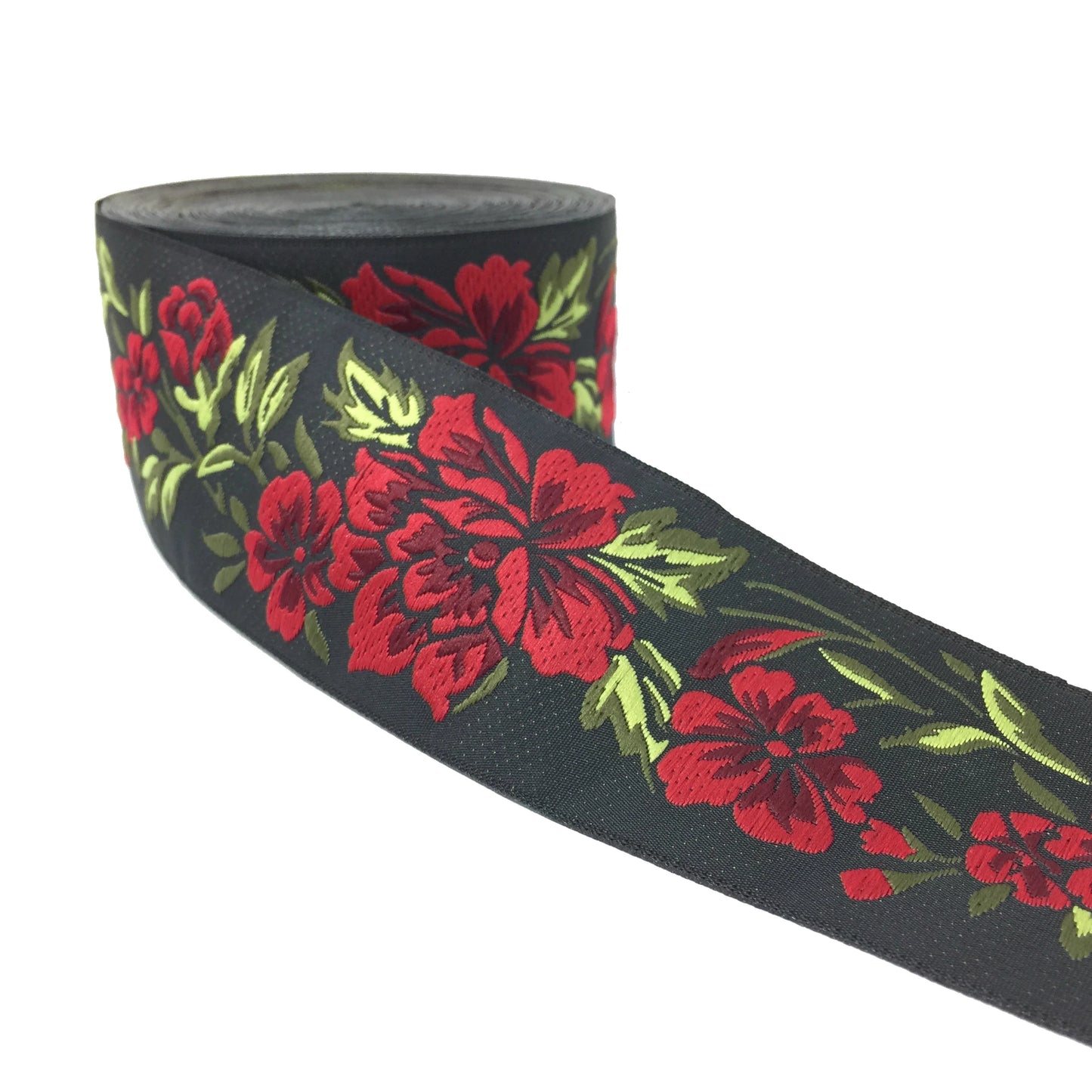 A roll of black grosgrain ribbon featuring a vibrant red floral and green leaf pattern, shown against a plain white background.