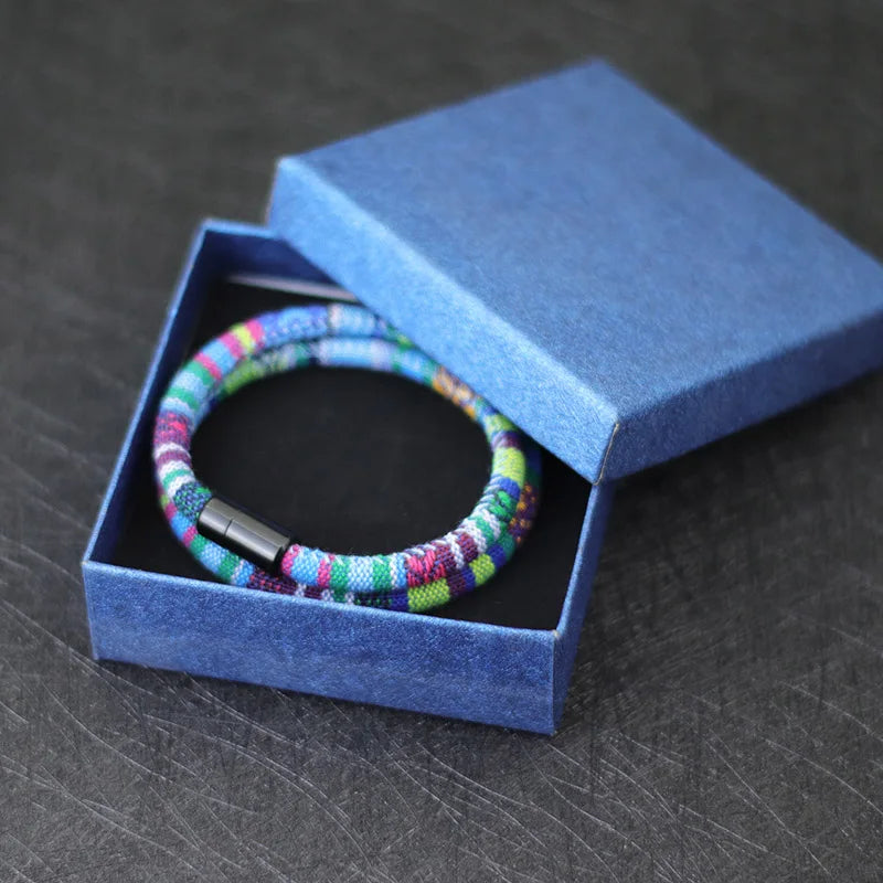 Multicolored bracelet in a blue box on a dark surface