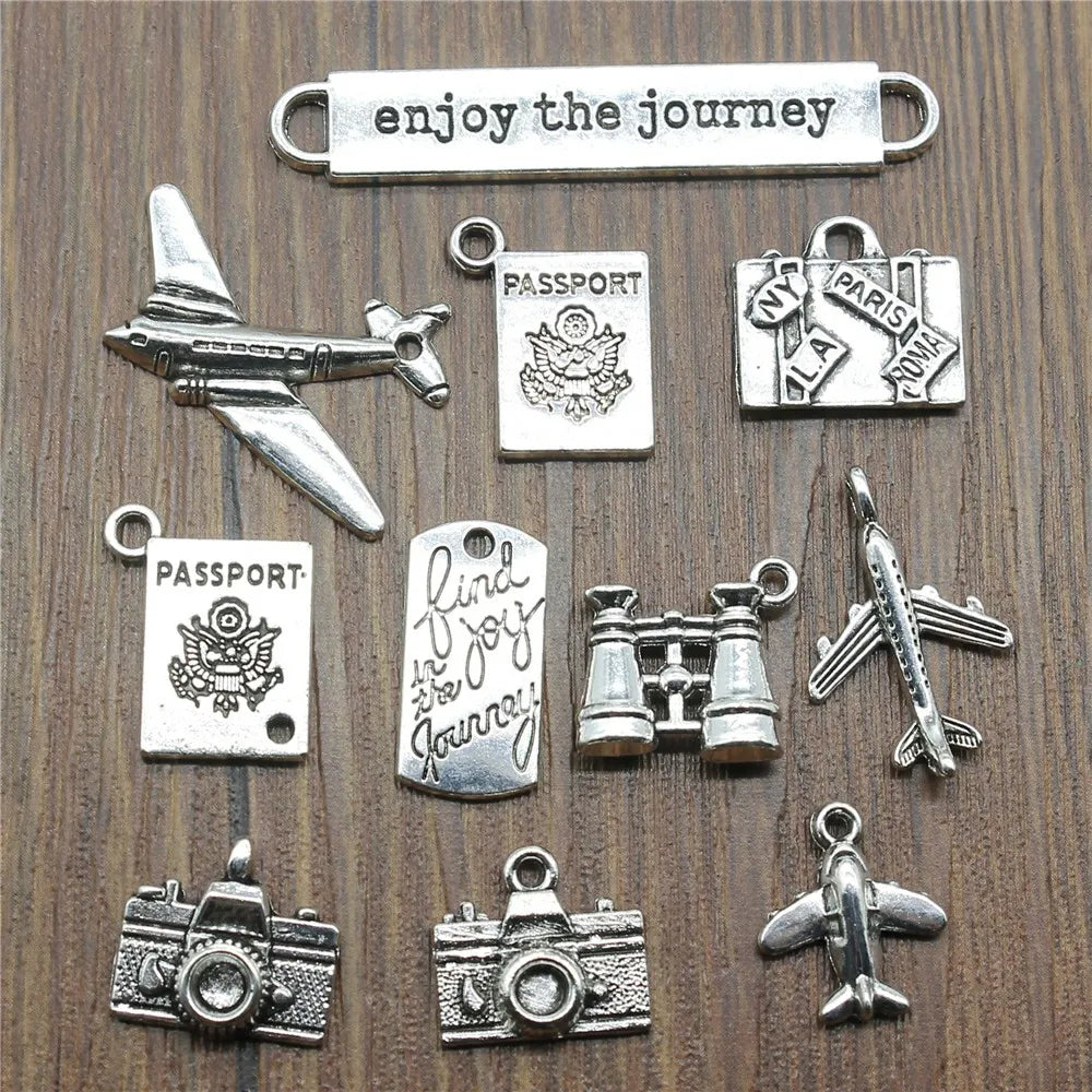 Travel charms for jewelry making featuring airplane, passport, suitcase and camera charms.