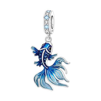 Blue betta fish-shaped charm with clear gemstones on a white background