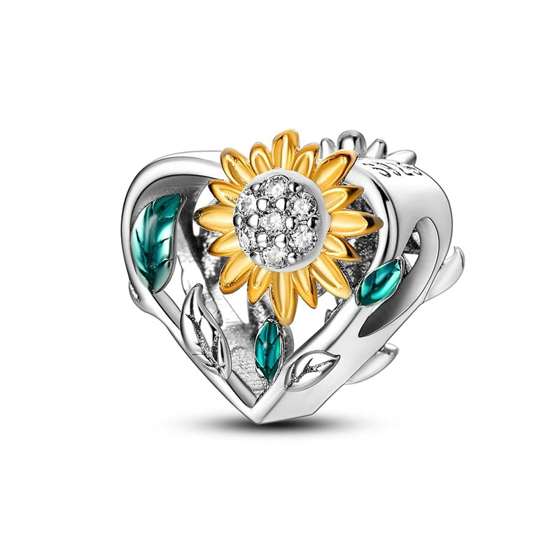 Silver charm with a heart and sunflower design on a white background