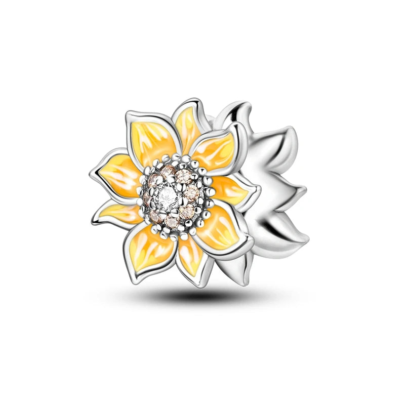 Sunflower-shaped charm with yellow petals and a silver border on a white background