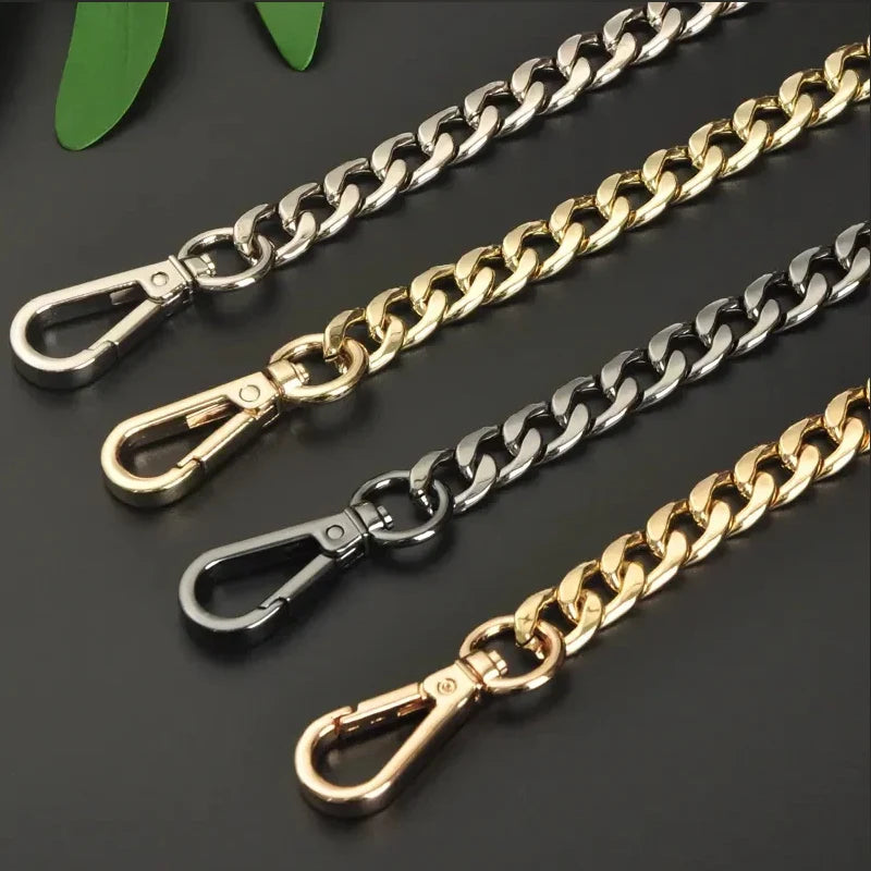 Four chain straps in gold, silver, sterling silver and black on a dark background.