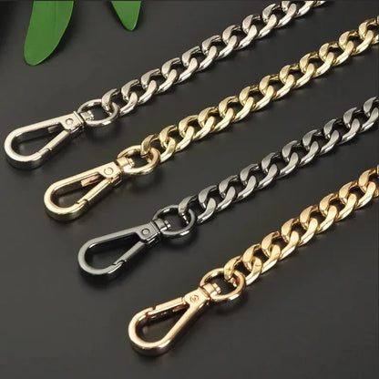 Four chain straps in gold, silver, sterling silver and black on a dark background.