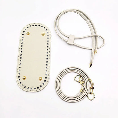 White leather pouch with gold accents and a matching strap on a white background