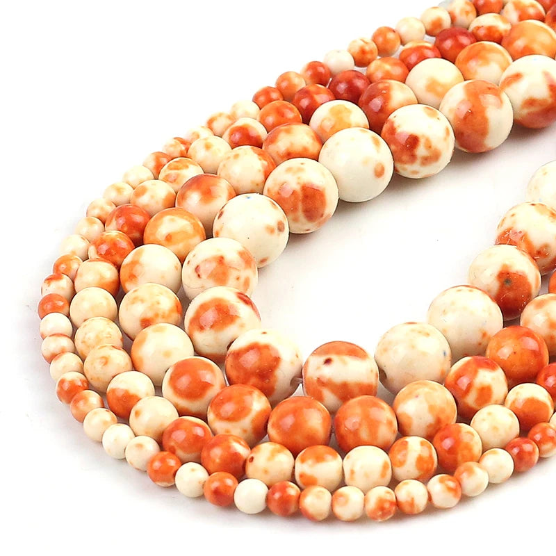 Marbled round beads in orange and cream, arranged in a spiral on a white background.