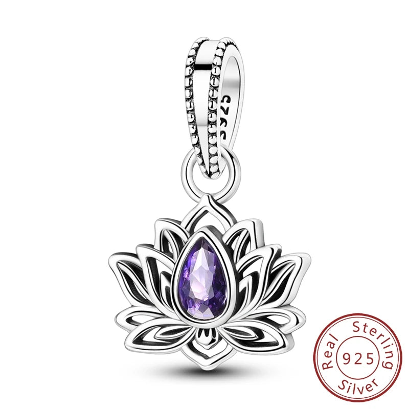A sterling silver lotus flower pendant charm featuring a faceted purple teardrop gemstone in the center, shown on a clean white background with a '925 Sterling Silver' stamp overlay in the bottom right corner.