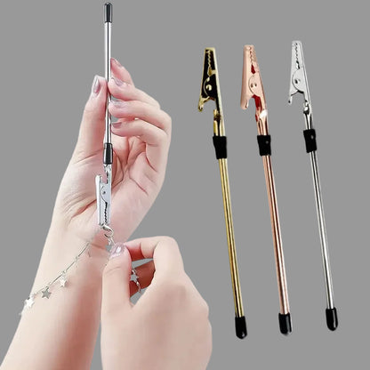 Jewelry handles with gold, rose gold, and silver finishes held by a hand.