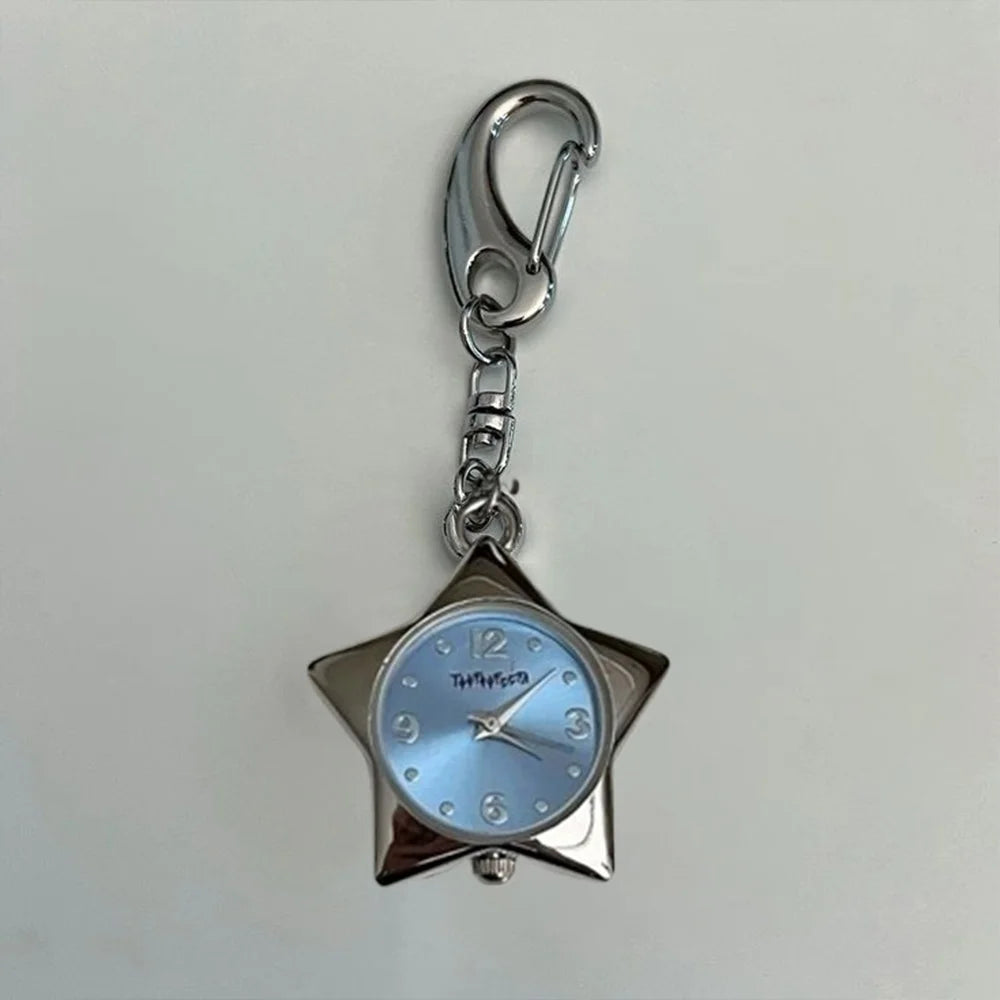 Star-shaped watch charm with blue face and silver casing on a light gray background