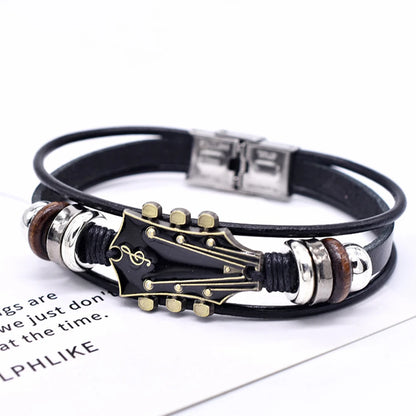 Guitar-shaped bracelet with black leather strap on a white background