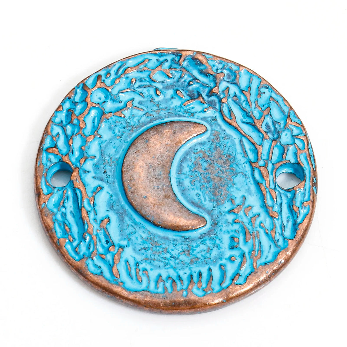 A round turquoise and copper pendant featuring a raised crescent moon in the center, with two pre-drilled holes on the sides, shown on a plain white background.