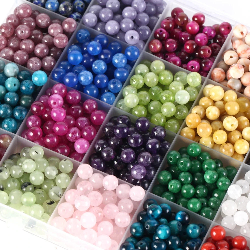 Assorted colored beads in small square compartments.